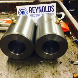 Stainless steel cylinders with the reynolds precision engineering logo